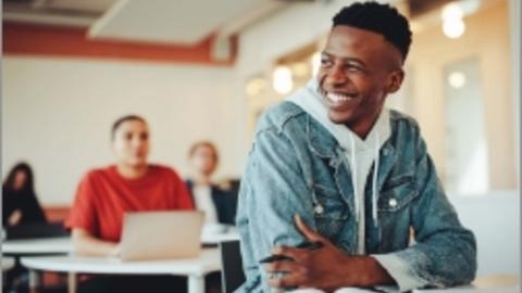Faith in Educational Renewal Text Thumbnail Image. African American Young man smiling with a jean jacket overlayed on a gray hoodie
