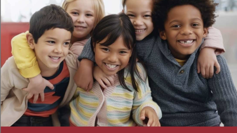 Five smiling children of varying races with their arms over each other's shoulders in a semi-embrace